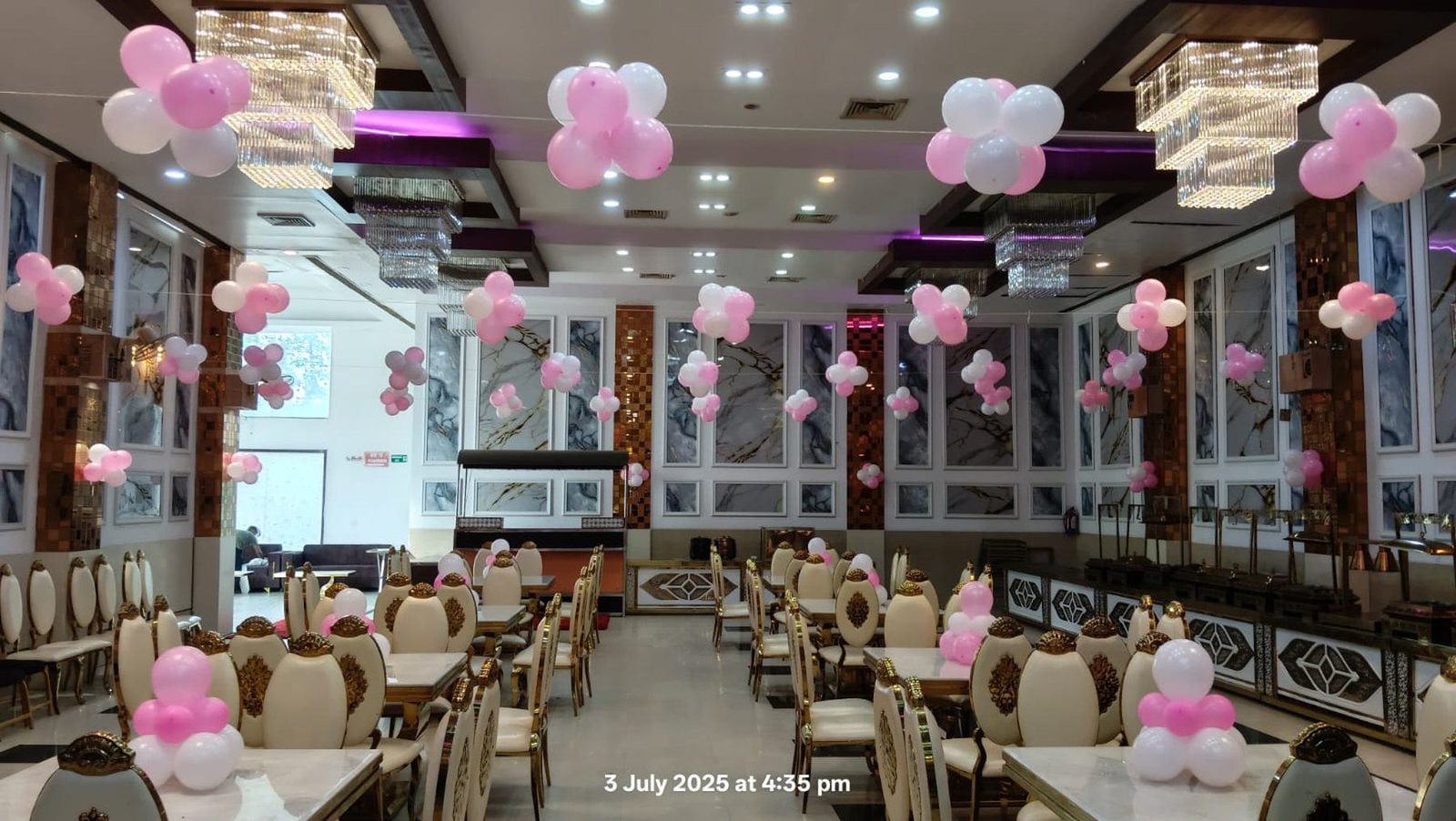 Awadh Greens banquet hall, decorated with chandeliers and balloon d\u00e9cor